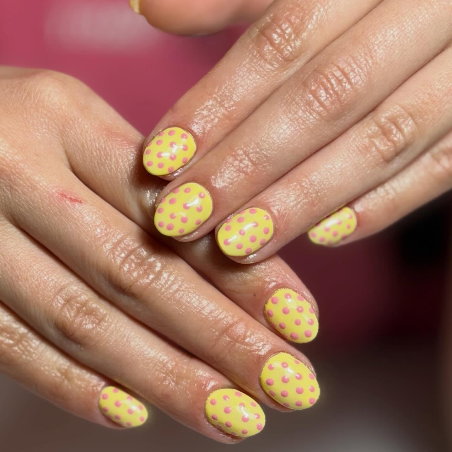 Yellow matte nails with pink polka dots