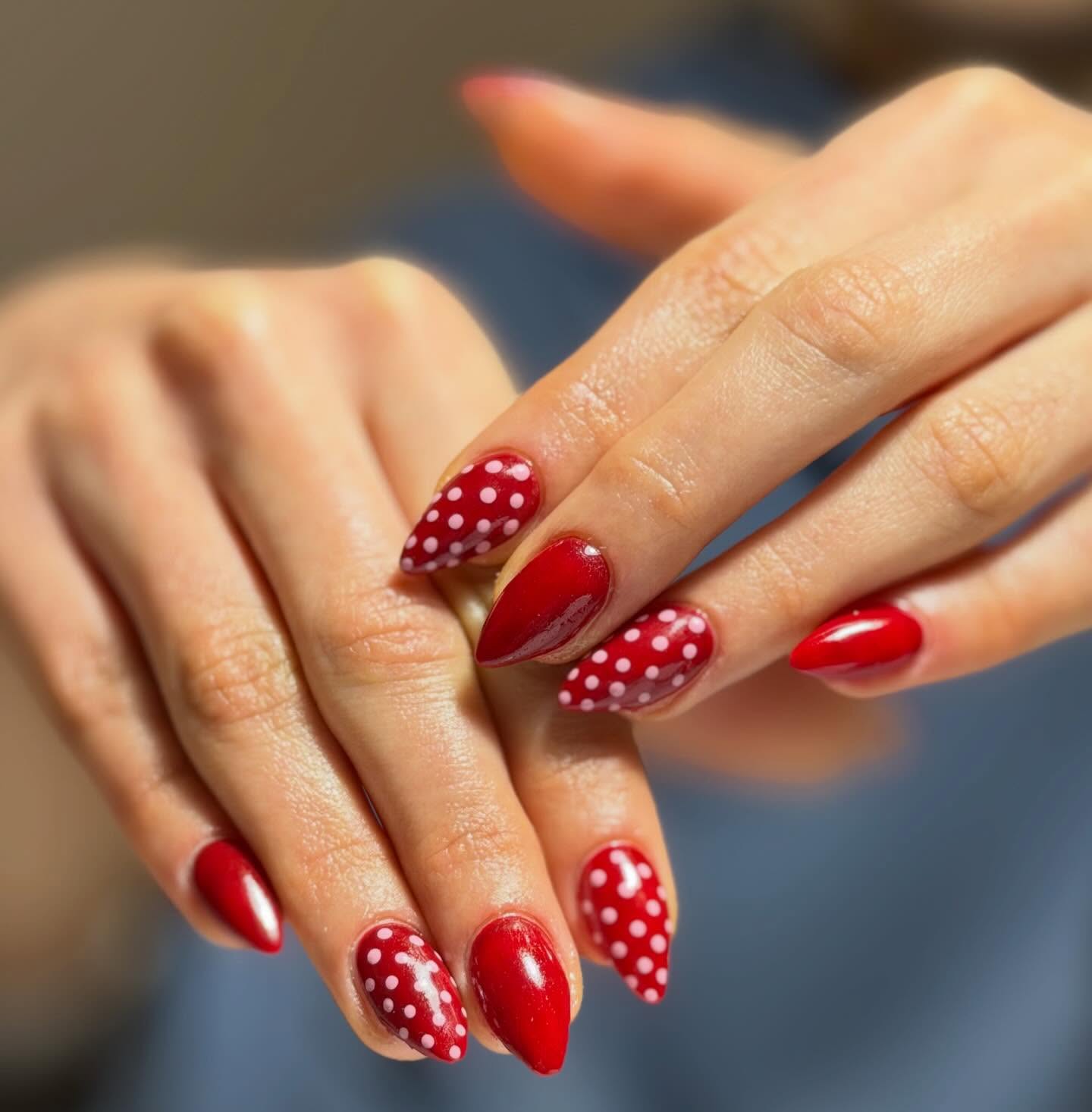 Red almond nails with white polka dots